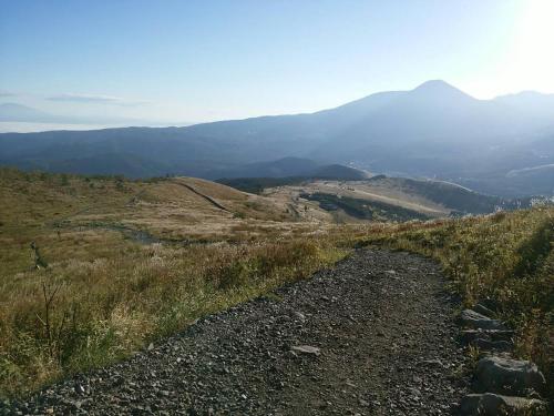 a path on a hill with mountains in the background at Hütte Jil Shirakabako in Chino