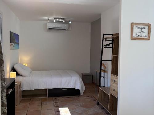a bedroom with a bed and a air conditioner at gite chez Galinette in Nissan-lez-Enserune