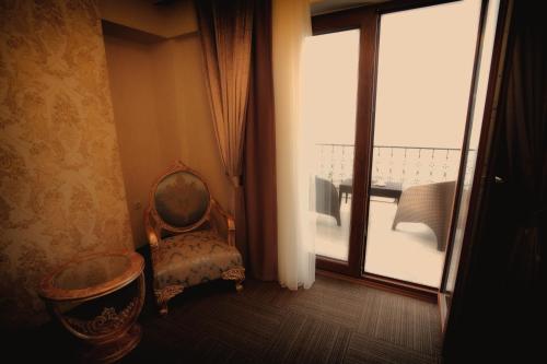 a room with a chair and a large window at Vurna Butik Hotel in Trabzon