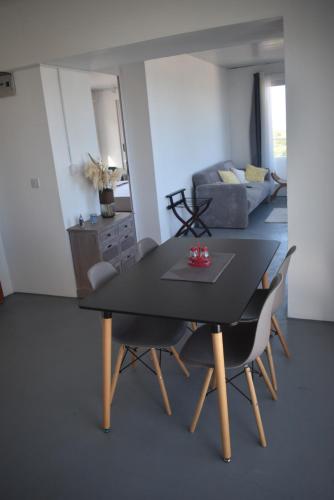 a dining table and chairs in a living room at Exceptional view! in Rivière Noire