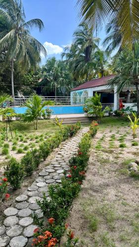 a house with a stone path leading to a swimming pool at Hotel Las Marias by Croma in Palomino
