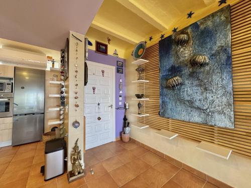 a kitchen with a large painting on the wall at Los Sauces in Roses