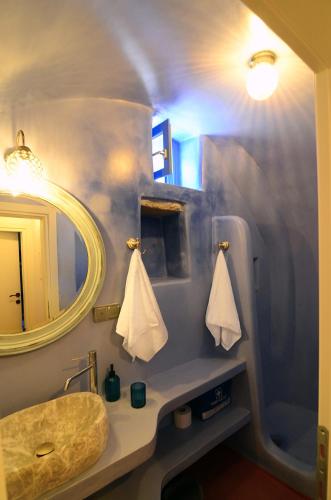 a bathroom with a sink and a mirror at Rodamia Traditional Cottage in Kythira