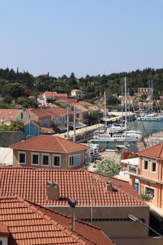 a view of a marina with houses and boats at Nafsika Apartments and Studios - Fiskardo in Fiskardho