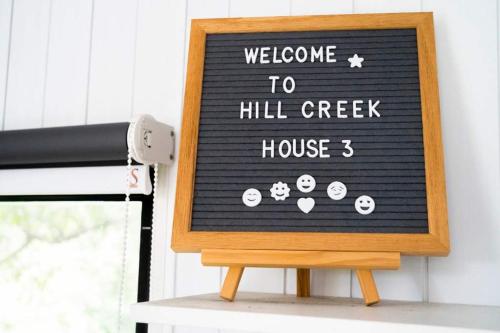 a sign that says welcome to hill creek house at Hill Creek Tiny House 3 by Tiny Away in Perwillowen