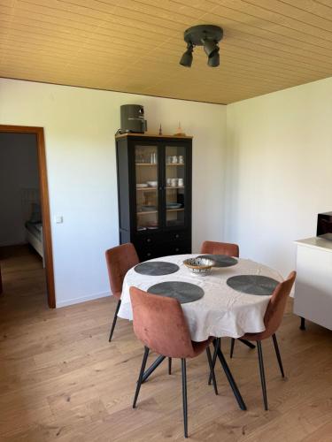 a dining room with a table and chairs at Living and feeling good in Burgbernheim