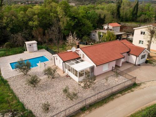 an aerial view of a house with a swimming pool at Holiday Home Slap Koćuša in Ljubuški