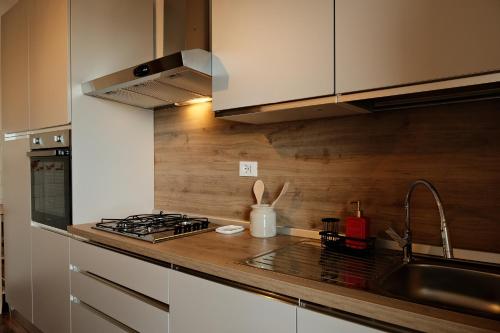 a kitchen with a sink and a stove top oven at Alba bordigotta in Bordighera