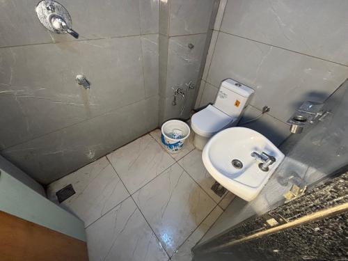 a small bathroom with a sink and a toilet at Hotel Dwarkadhish in Khātu