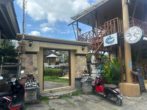 a couple of motorcycles parked outside of a building at Blue Lagoon Secret Villas in Nusa Lembongan