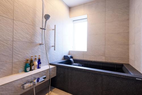a bathroom with a sink and a window at YuhigauraOnsen Umi no Hana in Kyotango