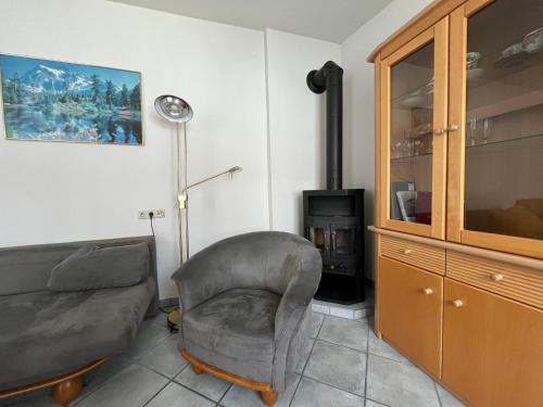 a living room with a chair and a stove at Aparthotel Mariazellerhof in Sankt Pölten