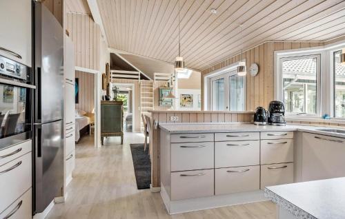 a kitchen with white cabinets and a refrigerator at Amazing Home In Kalundborg With Wifi in Kalundborg