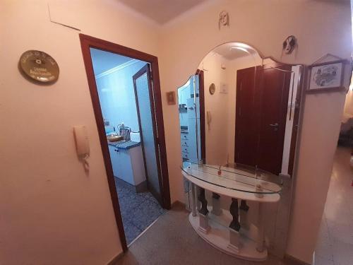 a bathroom with a sink and a mirror at Alojamiento El Sevillano in Cullera