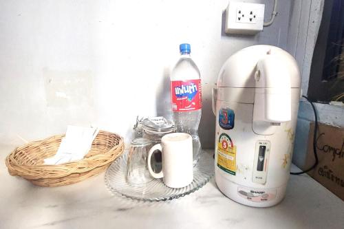 a mixer and a bottle of water on a counter at Sukhum Mega Bangna Guest House in Ban Khlong Thewa