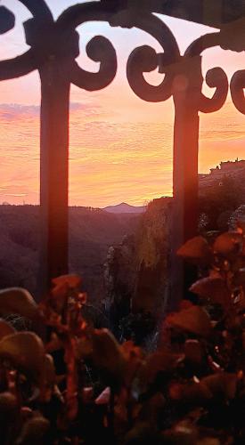 an image of two crosses with the sunset in the background at Antica Rupe Casa Vacanze in Castel SantʼElia