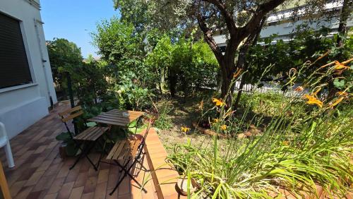 a bench sitting on a porch with a garden at Casa Kendra in Montegrotto Terme