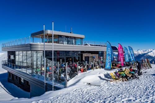 a building on top of a snow covered mountain at MY ALPENWELT Resort in Königsleiten