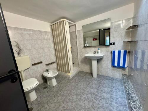 a bathroom with a toilet and a sink at Villa Ciaky in Leporano Marina