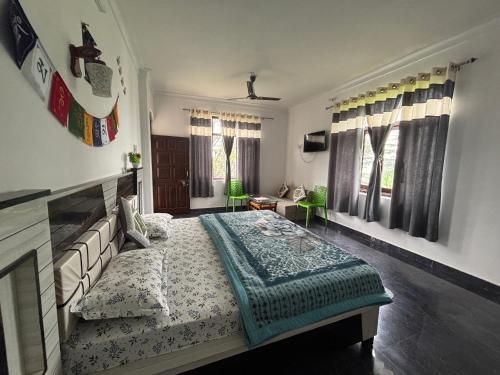 a bedroom with a large bed and windows at Sunrise home stay in Khajjiar 