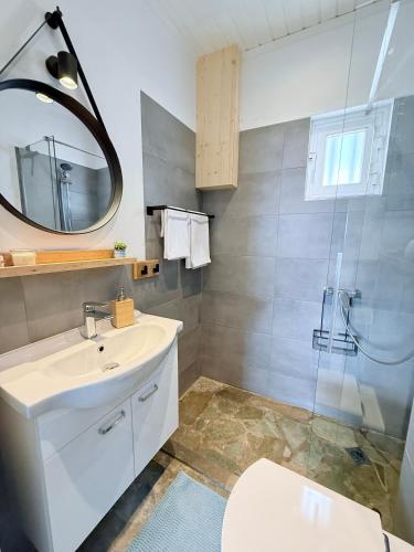 a bathroom with a sink and a shower at Amara Blue Bay Villa in Kalamos