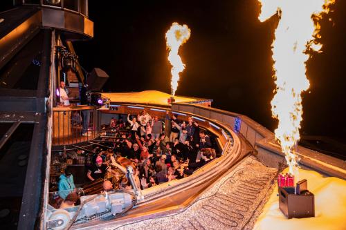 a group of people sitting on a roller coaster at MY ALPENWELT Resort in Königsleiten