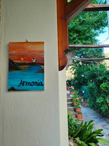 a painting on the side of a wall with a staircase at Armonia & Anemos Family Apartments in Kálamos