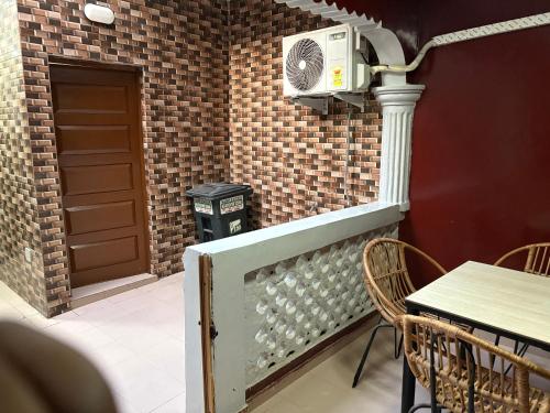 a dining room with a table and a trash can at Herb GraceTg in Kpoti