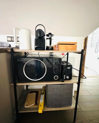 a tv and a camera on a shelf at Very Vilnius Pilies street in Vilnius