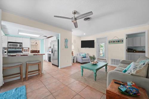 a living room with a couch and a table at Golf Cart-Jacuzzi-Surfing Abode on Hutchinson Island in Fort Pierce