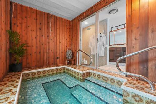 a bathroom with a swimming pool with a shower at Golf Cart-Jacuzzi-Surfing Abode on Hutchinson Island in Fort Pierce