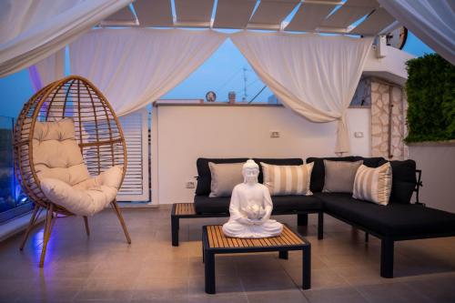 a living room with a couch and a statue on a table at Amarè Luxury Suite And Room Vista Mare in Bari