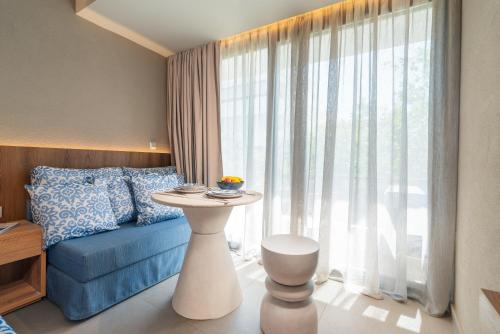 a bedroom with a bed and a table in front of a window at Cozy Suite in Rhodes Town