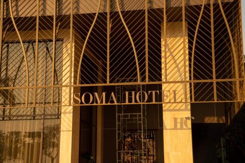 a building with a sign on the side of it at SOMA HOTEL Riverside in Phnom Penh