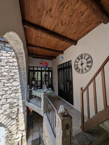 a staircase in a house with a wooden ceiling at Chambres de Saint Alban in Saint Alban Auriolles