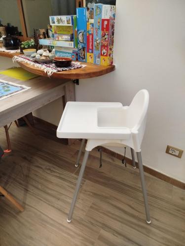 a white chair sitting in front of a desk at Rifugio Porta Nord in Sperlinga