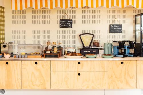 a bakery with a counter with food on it at DEMAIN Hôtel in Nantes