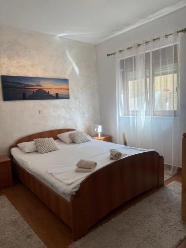 a bedroom with a large bed with two towels on it at Apartment Benvenuti in Kotor