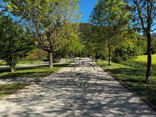a metal bench sitting in the middle of a road at Le Nid des Sources in Montbrun-les-Bains