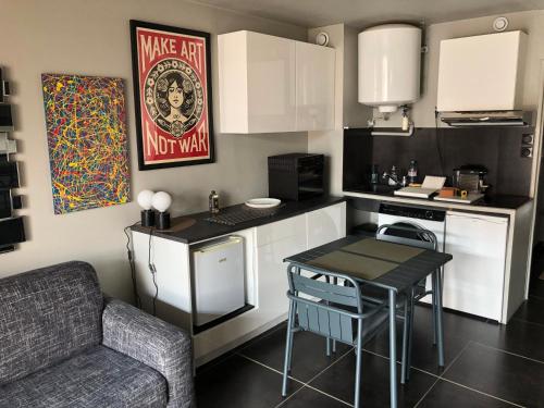 une petite cuisine avec une table et un canapé dans l'établissement Sanar'Studio, à Sanary-sur-Mer