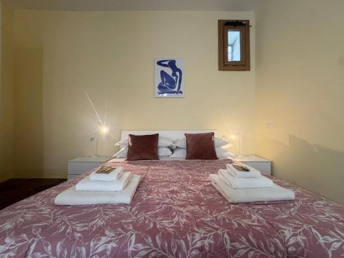 a bedroom with a large bed with towels on it at Le Due Torri in Rione Monti in Rome