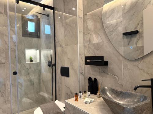 a bathroom with a shower and a sink at Celeste Luxury Villas in Lardos