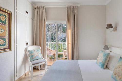 a bedroom with a bed and a chair at La Goleta in Llança