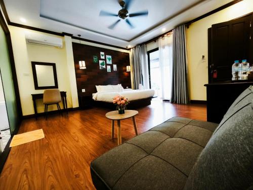 a living room with a couch and a ceiling fan at Meunna Boutique Hotel in Luang Prabang