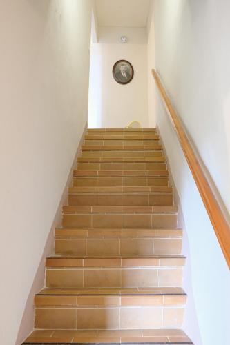 a staircase in a house with a clock on the wall at Panoramic Monferrato Villa With Garden & Amazing Views in Murisengo