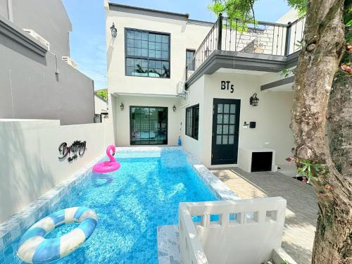 a swimming pool in the backyard of a house at Brittany Private Pool Villa-Pattaya in Na Jomtien