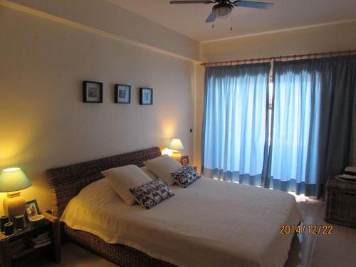 a bedroom with a large bed with two pillows on it at Quinta das Palmeiras - T2 in Porches