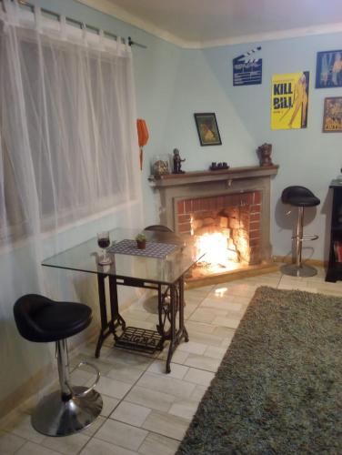 a living room with a table and a fireplace at Wind Guest House in Valparaíso