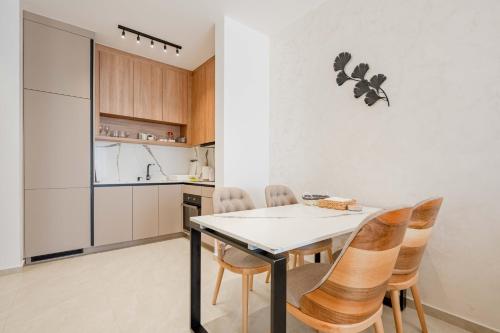 a kitchen and dining room with a table and chairs at Vienna Luxury Apartments in Dobra Voda