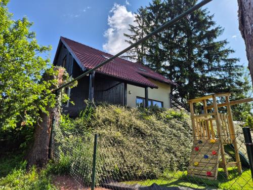 a house with a playground in front of it at Chalupa Mates Černý důl in Cerny Dul